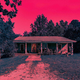 A photo of the Byers house from Stranger Things is shown with a hot pink overlay, making it spooky.